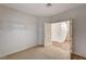 Clean bedroom with neutral carpet, open door to the hallway, and a shelf on the wall at 74 Harbor Coast St, Las Vegas, NV 89148