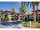 Elegant community clubhouse with stone accents, lush landscaping, and a circular driveway at 74 Harbor Coast St, Las Vegas, NV 89148