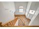 View of the entryway from the top of the staircase, showcasing the open floorplan and natural light at 74 Harbor Coast St, Las Vegas, NV 89148