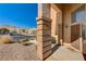 Covered front porch with view of street, desert landscaping and neighborhood at 74 Harbor Coast St, Las Vegas, NV 89148