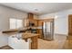 Well-equipped kitchen with stainless steel appliances, granite counters, and a breakfast bar with seating at 74 Harbor Coast St, Las Vegas, NV 89148