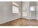 Bright living room features a wooden staircase, tile flooring, and tall windows at 74 Harbor Coast St, Las Vegas, NV 89148