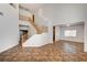 Bright living room features a wooden staircase and tile flooring at 74 Harbor Coast St, Las Vegas, NV 89148