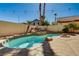 Inviting pool with a rock waterfall feature, lush landscaping, and string lights at 74 Harbor Coast St, Las Vegas, NV 89148