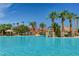 Resort-style pool with palm trees and a splash park, perfect for relaxation and Gathering fun at 74 Harbor Coast St, Las Vegas, NV 89148