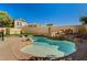 Backyard pool featuring a rock waterfall feature and surrounding stone patio at 74 Harbor Coast St, Las Vegas, NV 89148