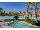 Resort-style pool area with a hot tub and swaying palm trees against a clear blue sky at 74 Harbor Coast St, Las Vegas, NV 89148