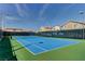 A community tennis court is surrounded by lush greenery and nearby homes, for a convenient, active lifestyle at 74 Harbor Coast St, Las Vegas, NV 89148