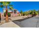 Backyard view with desert landscaping, minimal plants, and a neighboring two-story home at 7623 Calm Passage Ct, Las Vegas, NV 89139