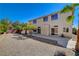 Back exterior view with desert landscaping, palm trees, and a concrete patio at 7623 Calm Passage Ct, Las Vegas, NV 89139