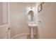 Charming powder room with pedestal sink and neutral tile flooring at 7623 Calm Passage Ct, Las Vegas, NV 89139