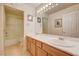 Bright bathroom featuring a dual sink vanity with wood cabinets and a shower-tub combo at 7623 Calm Passage Ct, Las Vegas, NV 89139