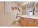 Well-lit bathroom features a sink, toilet, mirror, and shower for daily convenience at 7623 Calm Passage Ct, Las Vegas, NV 89139