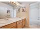 Bright bathroom with double sinks, framed mirror and a shower-tub combination at 7623 Calm Passage Ct, Las Vegas, NV 89139