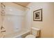 Well-lit bathroom with a white tiled shower-tub combination and a modern toilet at 7623 Calm Passage Ct, Las Vegas, NV 89139