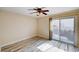 A bright bedroom features a ceiling fan and sliding glass door to the backyard at 7623 Calm Passage Ct, Las Vegas, NV 89139