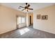 Cozy bedroom with plush carpet, fan, and natural lighting from the window at 7623 Calm Passage Ct, Las Vegas, NV 89139