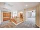 Well-lit hallway with carpeted floors and built-in wood cabinets near staircase at 7623 Calm Passage Ct, Las Vegas, NV 89139