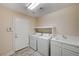 This laundry room features a washer, dryer, and sink, offering convenience and efficiency at 7623 Calm Passage Ct, Las Vegas, NV 89139