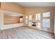 Bright and airy living room with vaulted ceilings, wood-look floors, and a modern fireplace at 7623 Calm Passage Ct, Las Vegas, NV 89139