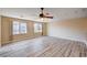 Large living room featuring hardwood floors, ceiling fan, and natural light at 7623 Calm Passage Ct, Las Vegas, NV 89139