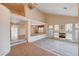 Spacious living room featuring vaulted ceilings, an open floor plan, a fireplace, and natural light at 7623 Calm Passage Ct, Las Vegas, NV 89139