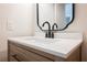 Bathroom features a white countertop, wood vanity, and black modern faucet at 764 Biaritz Ave, Las Vegas, NV 89123