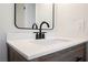 Close-up of a bathroom vanity with matte black faucet and decorative mirror at 764 Biaritz Ave, Las Vegas, NV 89123