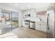 Stylish kitchen featuring white cabinets, stainless steel appliances, and a view of the backyard pool through sliding glass doors at 764 Biaritz Ave, Las Vegas, NV 89123