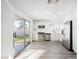 Modern kitchen featuring white cabinetry, stainless steel appliances, and a sliding door to the backyard at 764 Biaritz Ave, Las Vegas, NV 89123