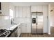 Well-lit kitchen featuring white cabinets, stainless steel appliances, and modern finishes at 764 Biaritz Ave, Las Vegas, NV 89123