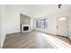 Inviting living room features a fireplace, large window, and new flooring, creating a warm and welcoming space at 764 Biaritz Ave, Las Vegas, NV 89123