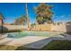 Sparkling swimming pool in a well-maintained backyard with grassy area at 764 Biaritz Ave, Las Vegas, NV 89123