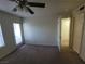 View of the carpeted bedroom with a ceiling fan and doors at 7730 Secret Shore Dr # 207, Las Vegas, NV 89128