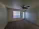 Neutral-toned bedroom features a ceiling fan and closet, offering a serene and comfortable living space at 7730 Secret Shore Dr # 207, Las Vegas, NV 89128