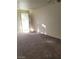 Empty apartment living room featuring neutral walls, carpeted floors, and a view towards a doorway at 7730 Secret Shore Dr # 207, Las Vegas, NV 89128