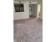 Apartment living space with an open design, including views of the kitchen and the in-unit laundry appliance at 7730 Secret Shore Dr # 207, Las Vegas, NV 89128