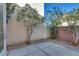 An outdoor patio featuring a concrete surface and minimalist landscaping for relaxing and entertaining at 7978 Light Tower St, Las Vegas, NV 89139