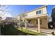 Backyard with a covered patio, manicured lawn, block wall, and a flowering tree at 8223 Saddleback Ledge Ave, Las Vegas, NV 89147