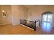 Bright foyer with hardwood floors, chandelier, and staircase leading up to french doors and outdoor area at 8223 Saddleback Ledge Ave, Las Vegas, NV 89147