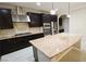 A well-appointed kitchen featuring stainless steel appliances, granite countertops, and dark cabinetry at 8223 Saddleback Ledge Ave, Las Vegas, NV 89147