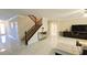 Bright living room showcasing tile floors, staircase, and entry door for a welcoming atmosphere at 8223 Saddleback Ledge Ave, Las Vegas, NV 89147