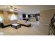 Expansive living room with tile floors, an oversized sofa, and an open layout to the kitchen at 8223 Saddleback Ledge Ave, Las Vegas, NV 89147