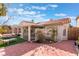 Inviting backyard showcasing a covered patio, mature palm trees, and a meticulously landscaped garden at 8520 Copper Falls Ave, Las Vegas, NV 89129