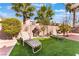 Inviting backyard with green grass, palm trees, lounge chairs, and desert landscaping creating a relaxing outdoor oasis at 8520 Copper Falls Ave, Las Vegas, NV 89129