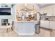 An open kitchen featuring white cabinetry, stainless steel appliances, and a breakfast bar at 8520 Copper Falls Ave, Las Vegas, NV 89129