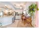 Bright kitchen featuring stainless steel appliances, white cabinets, granite countertops, and dining area at 8520 Copper Falls Ave, Las Vegas, NV 89129