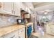 Bright kitchen with granite counters, stainless appliances, and a view of the dining area at 8520 Copper Falls Ave, Las Vegas, NV 89129