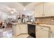 Bright kitchen with granite countertops, white cabinets, an island, and a view to the dining area at 8520 Copper Falls Ave, Las Vegas, NV 89129