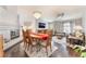 Open concept living room with fireplace, dining area, and modern chandelier at 8520 Copper Falls Ave, Las Vegas, NV 89129